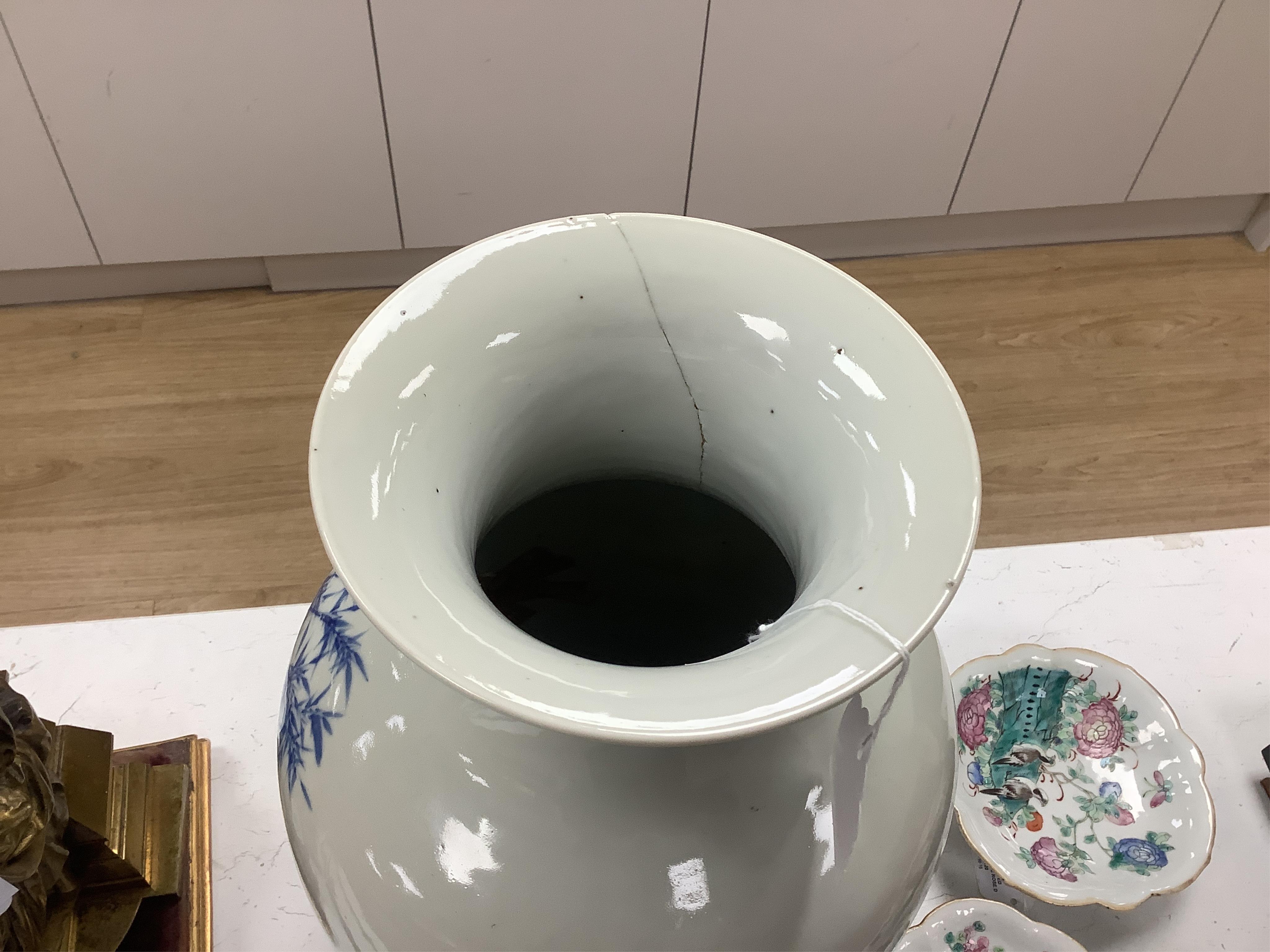 A large Chinese blue and white figural vase. 46cm high. Condition - large crack through from top to bottom of vase.